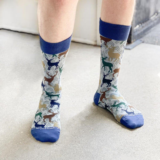 Men's Stag Socks: Light blue with multicolored pony prints and dark blue trim. Cover up to calves. Made from combed cotton. Sizes available: M, L, XL.