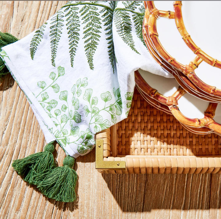 White dish towels with green fern and leaf prints, green tassels. Available in 16"x28" size. Absorbent and decorative.