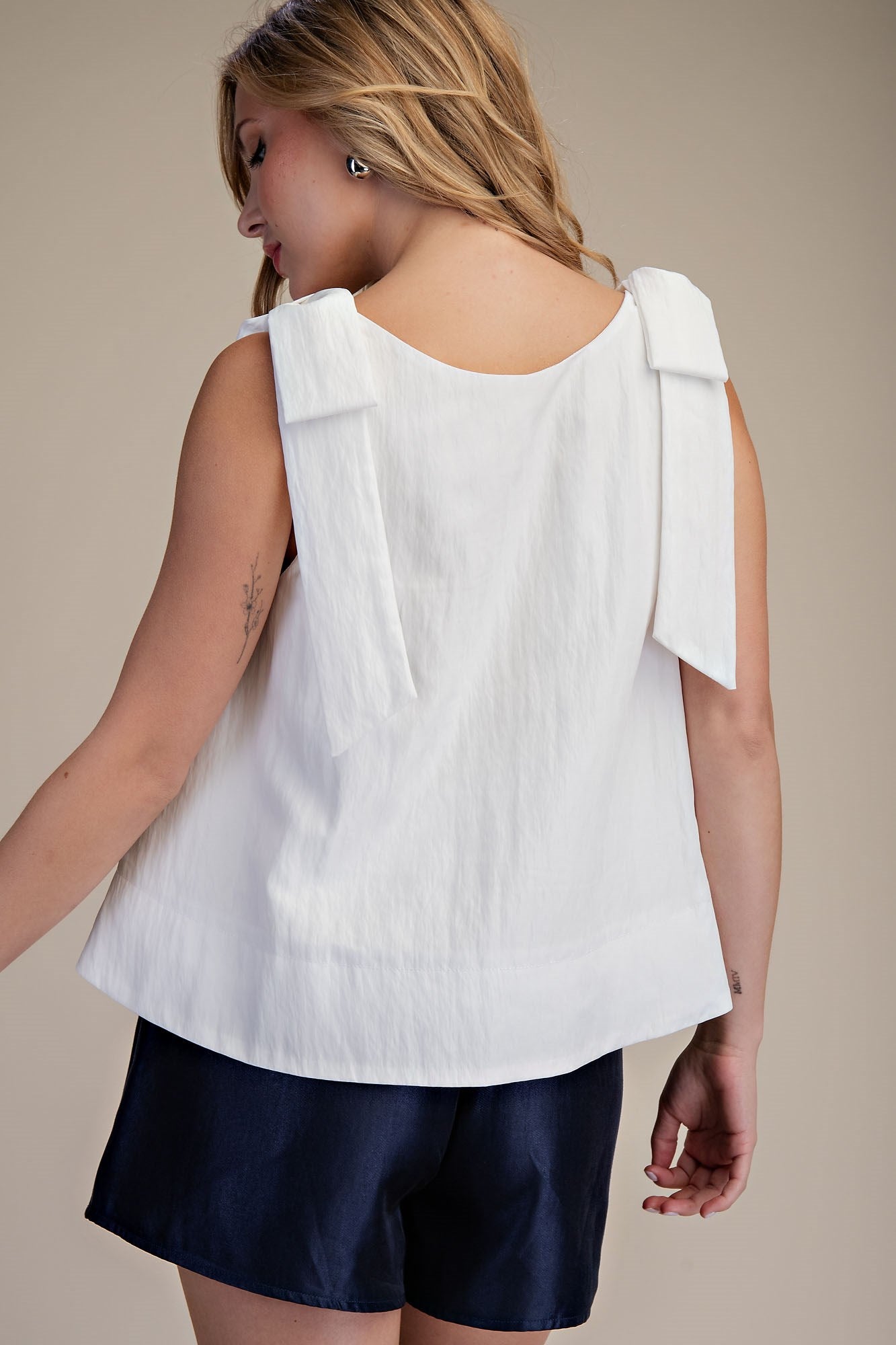 White Scoop Neck Bow Shoulder Top, features bow details on shoulders. Available in sizes XS-XL.