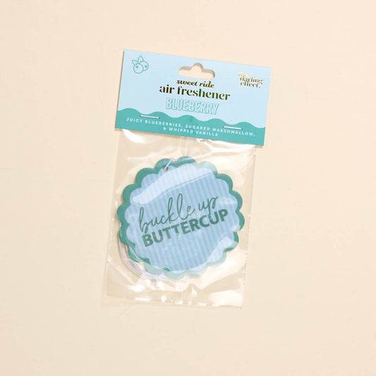Scalloped circle air freshener with "buckle up BUTTERCUP" in blue; blueberry, marshmallow, vanilla scent. Sizes: small, large.
