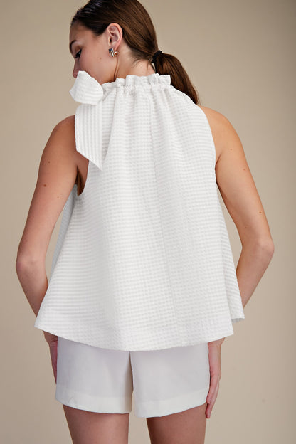 White Ruffle Neck Tie Sleeveless Top, available in sizes XS-XL. Features ruffle neckline and back tie detail.