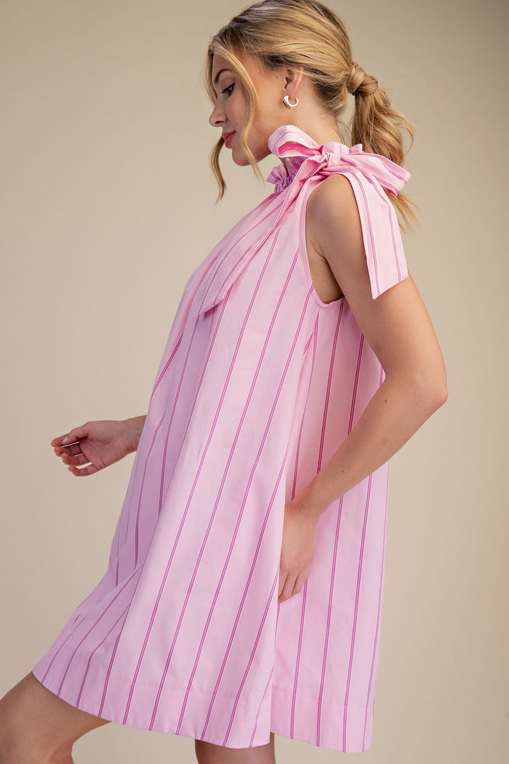 Pinstripe Pink Tie-Neck Sleeveless Dress with red stripes, bow, pockets, loose fit. Available in XS–XL.