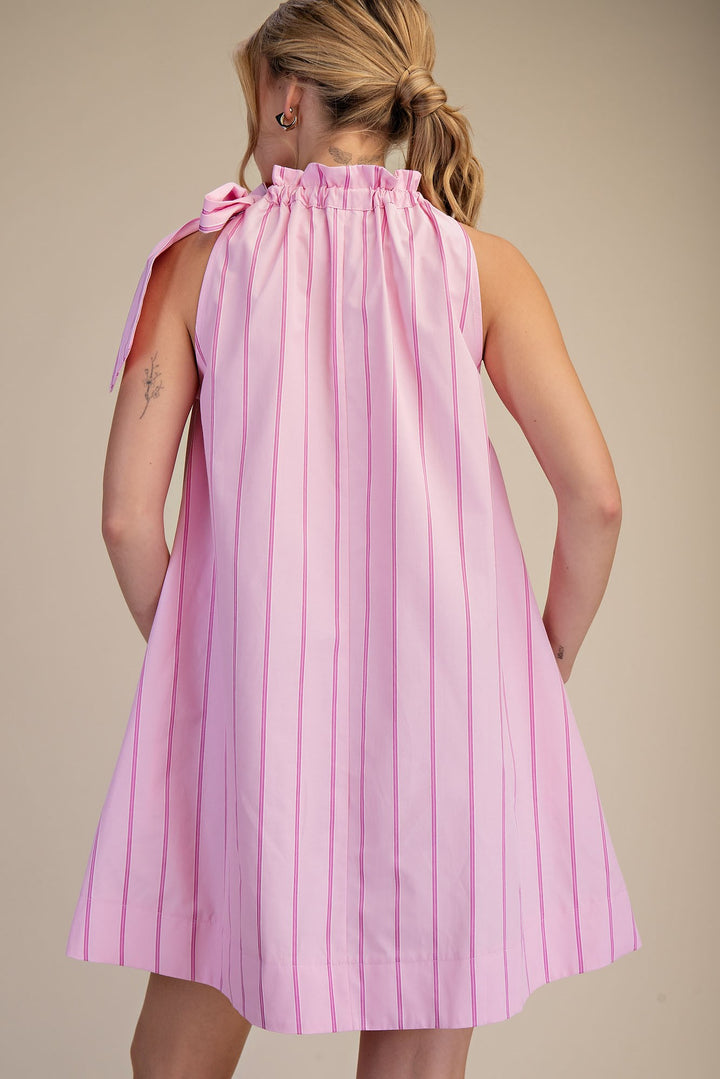 Pinstripe Pink Tie-Neck Sleeveless Dress with ruffled collar and bow at shoulder. Available in sizes XS-XL.