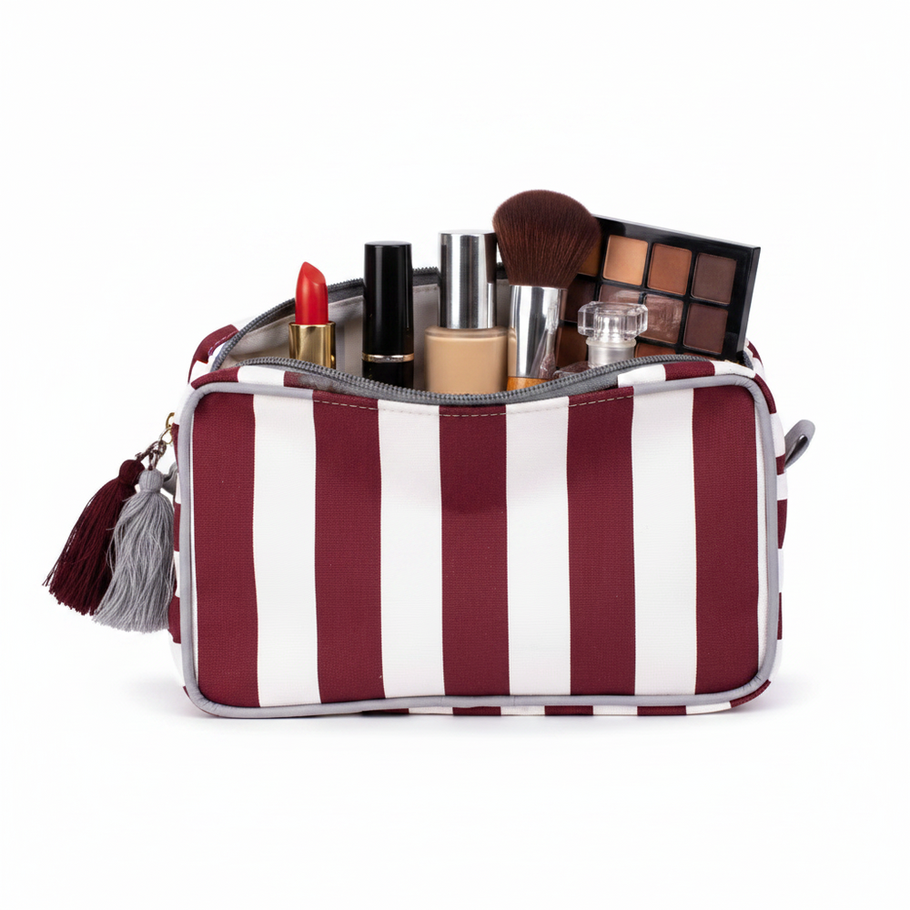 Maroon and white stripe Megan Cosmetic Bag with tassel accents, unzipped. Available sizes: small, medium, large.