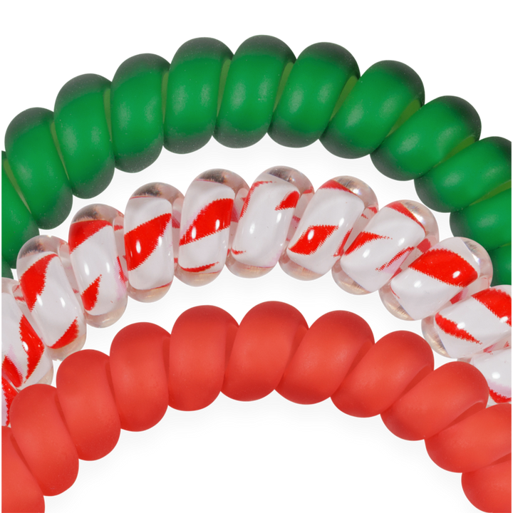 Set of three small spiral hair ties in solid green, candy cane striped, and solid red.