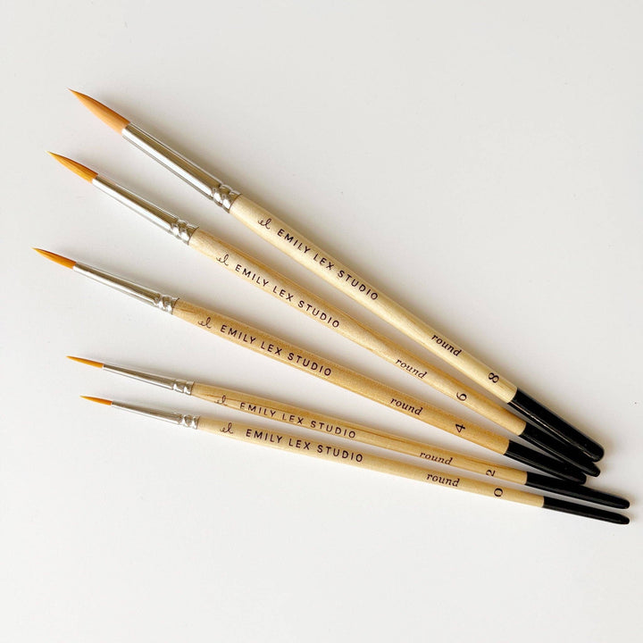 Size 0 "Emily Lex Studio" watercolor paintbrush with light wooden handle and pointed synthetic taklon bristles. Sizes available.
