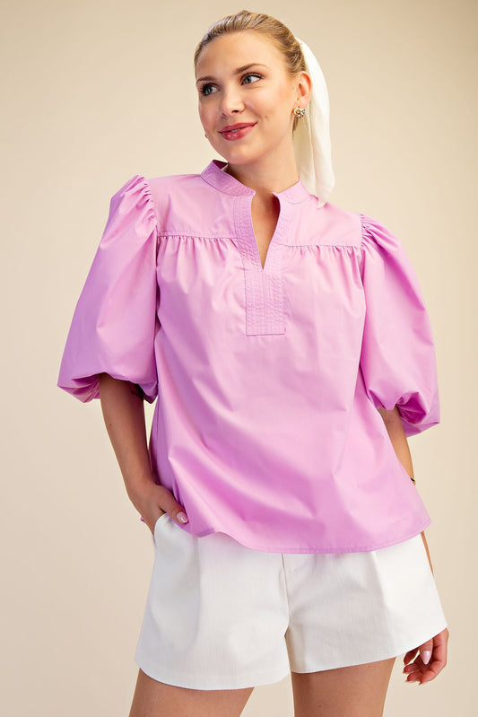 Lilac V-Neck Bubble Sleeve Poplin Top, available in sizes XS-XL. Features bubble sleeves and v-neck design.