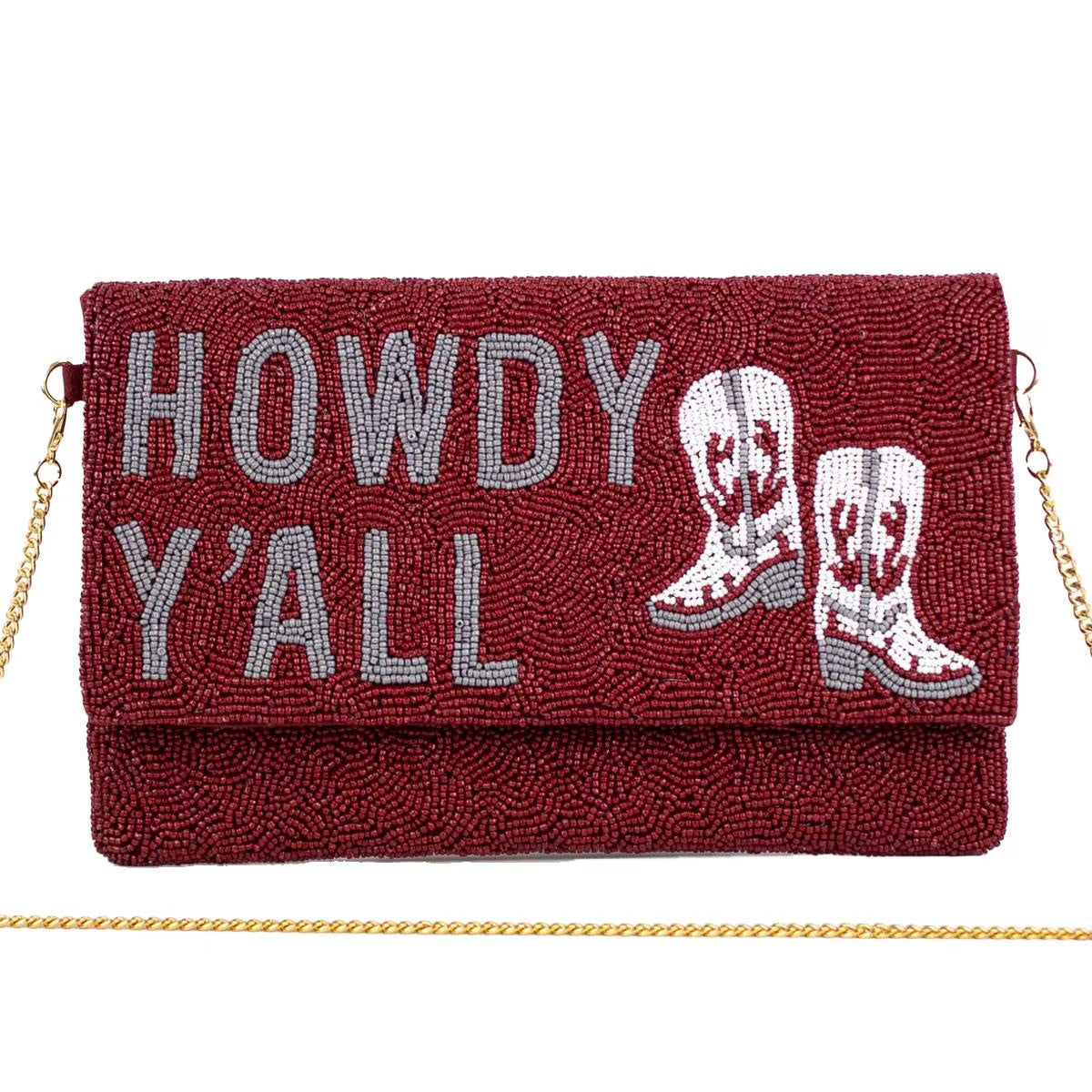 Beaded clutch with red beads, gray “HOWDY Y’ALL” lettering, white cowboy boots, gold chain strap. Size: 10" x 6".