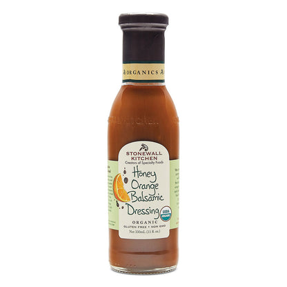 11 fl oz bottle of organic Honey Orange Balsamic Dressing with green-white label, orange slice image, and gluten-free note.