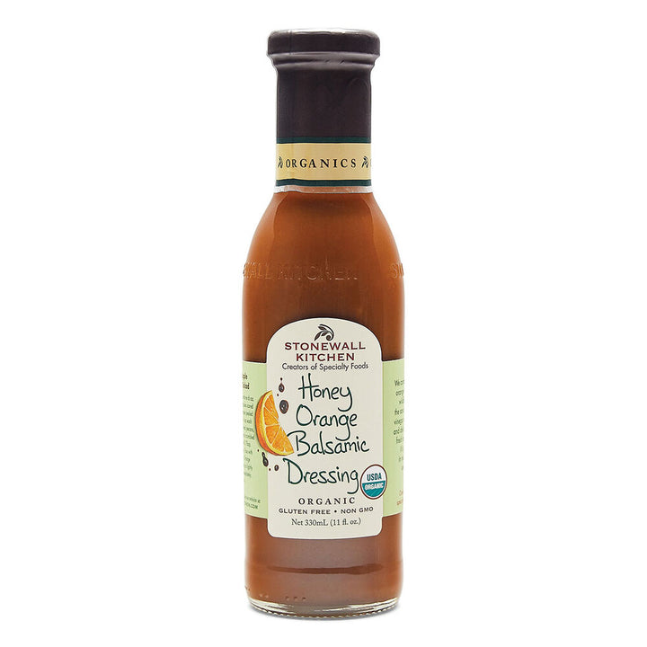 11 fl oz bottle of organic Honey Orange Balsamic Dressing with green-white label, orange slice image, and gluten-free note.