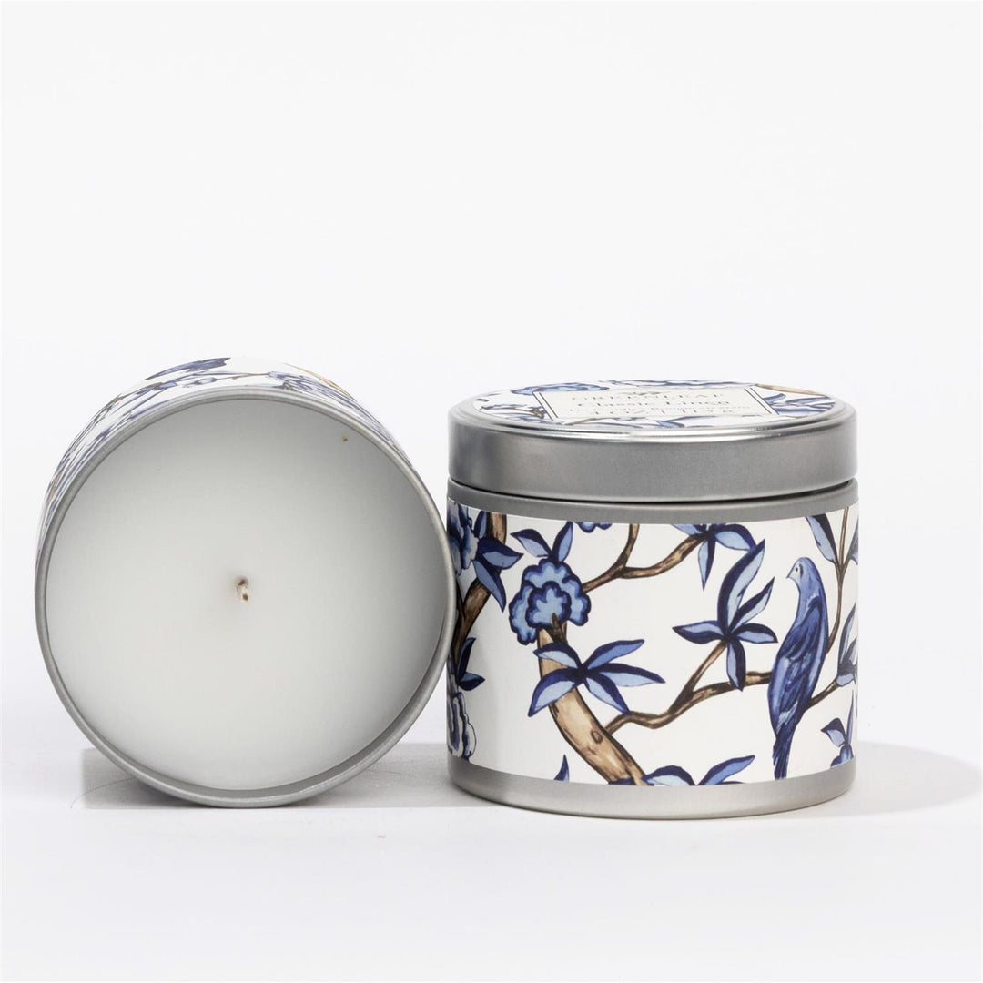 Classic Linen Tin Candle: white tin, blue and white floral and bird design, fresh Greenleaf scent. Available in multiple sizes.