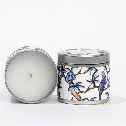 Classic Linen Tin Candle: white tin, blue and white floral and bird design, fresh Greenleaf scent. Available in multiple sizes.