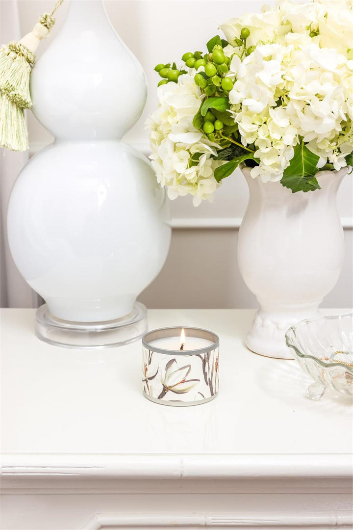 Magnolia Tin Candle with fresh magnolia scent. Available in 8oz and 16oz sizes. Simple tin design.