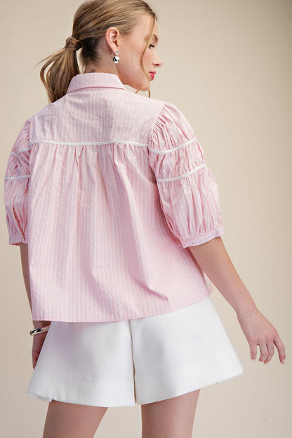 Gathered Piping Striped Blouse shown from the back in one of 2 colors. Available in sizes XS to XL.