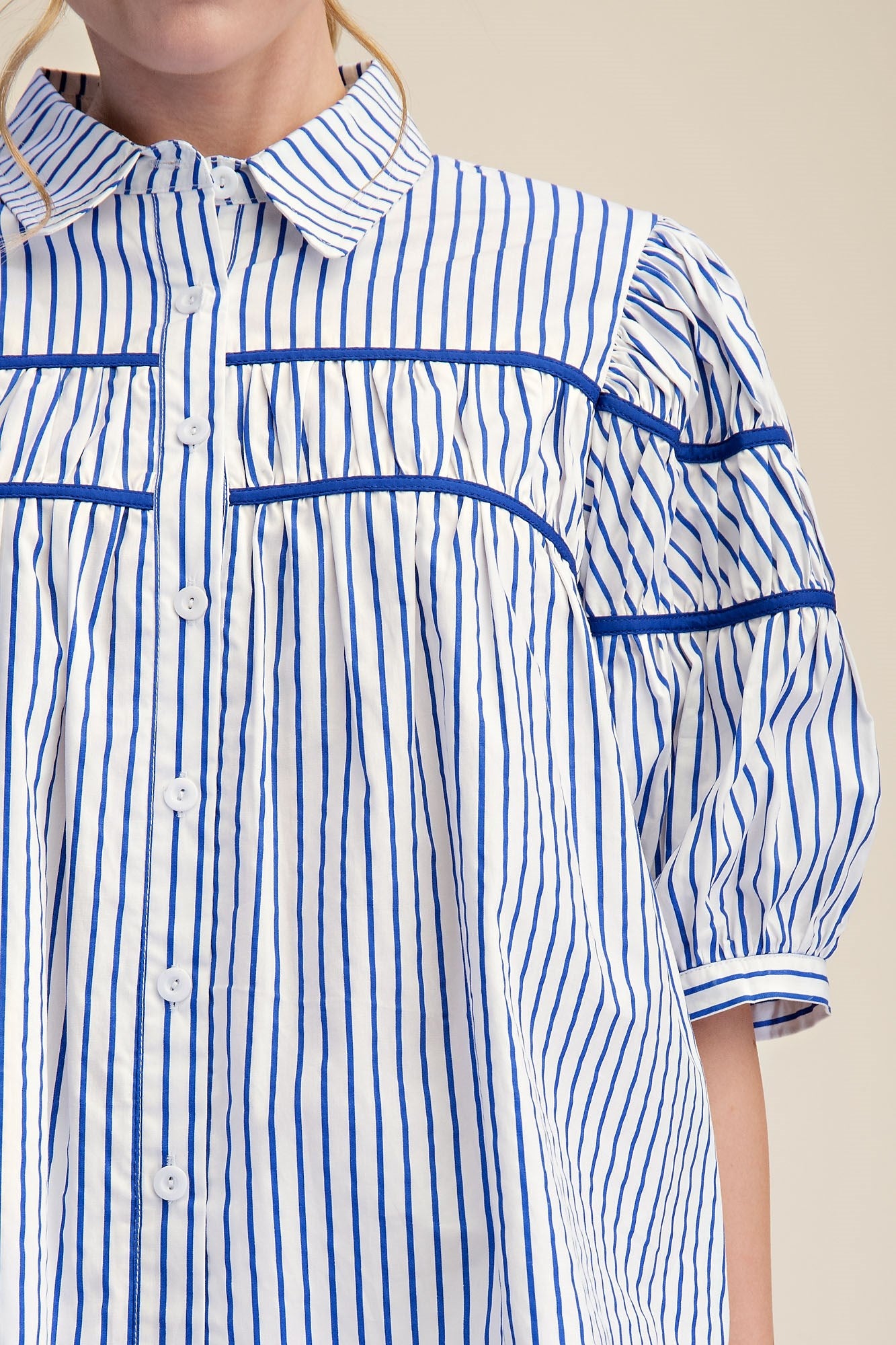 Blue and white striped blouse with puff short sleeves and collar. Available in 2 colors, sizes XS-XL.
