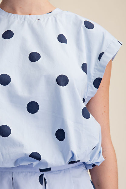 Blue Polka Dot Bubble Top: light blue, short sleeves, large dark blue dots. Available in sizes XS-XL.