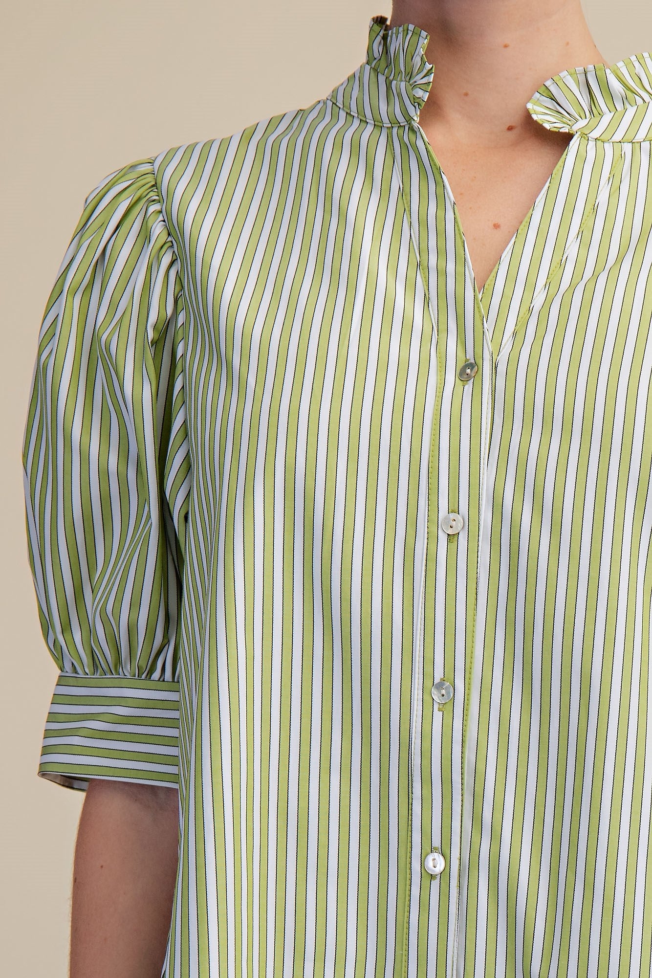 Striped Sage Ruffle Dress with sage and white stripes, ruffle neckline, puff sleeves, buttons. Sizes: XS-XL.
