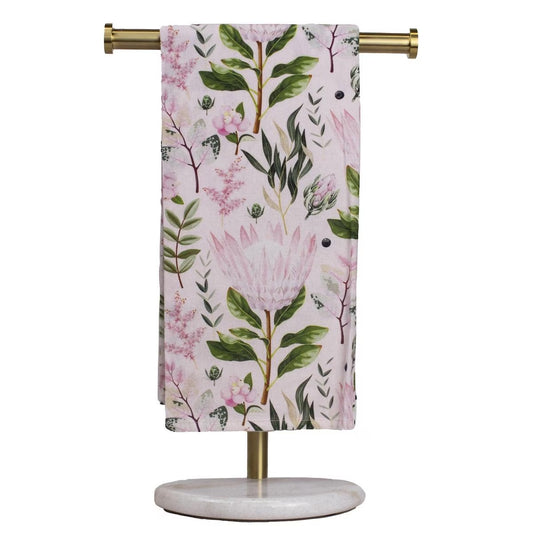 The Secret Garden Hand Towel features floral and leaf patterns in pink and green on a soft background. Available sizes: One size.