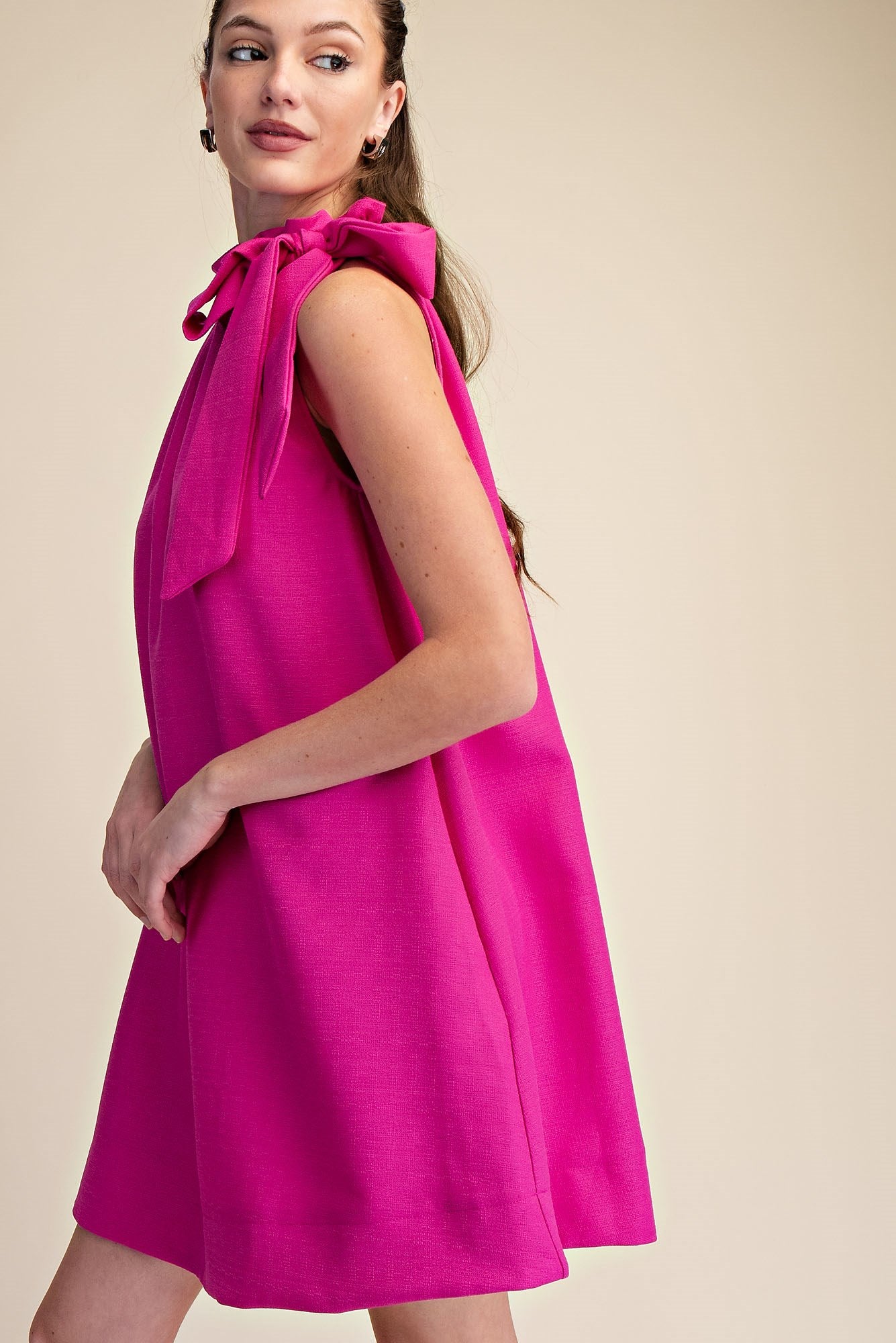 Magenta Tie-Neck Sleeveless Dress with a fitted silhouette. Available in sizes XS–XL.