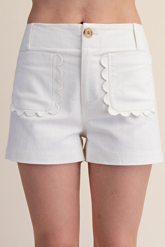 High-waisted white shorts with scalloped pockets, button closure. Available in sizes XS-XL.