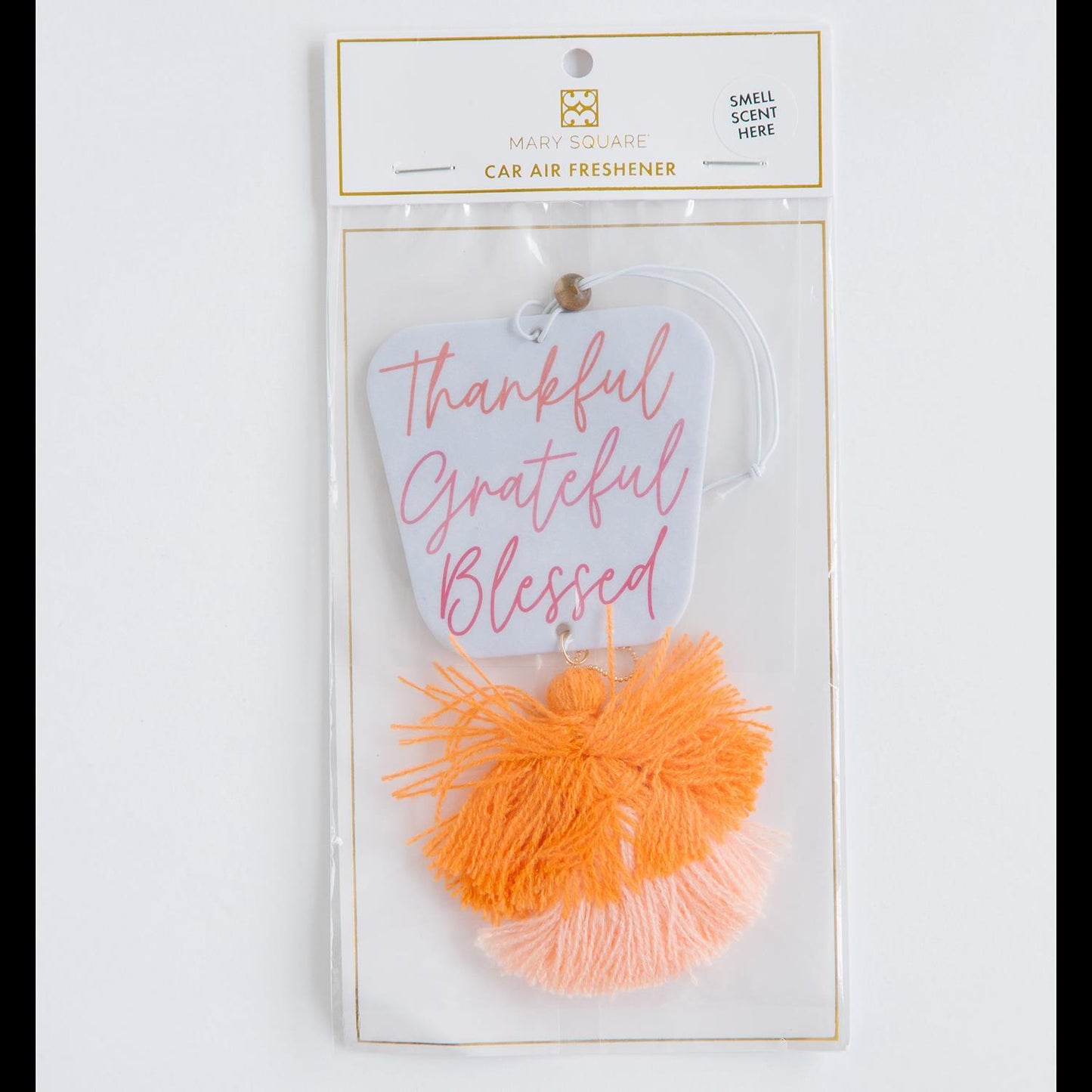 Fall Scented Air Freshener: A car mirror accessory with "Thankful, Grateful, Blessed" in pink script and orange and peach tassels. Infused with harvest spice and vanilla fragrance. Includes a "Smell Scent Here" label. Available size: Standard.