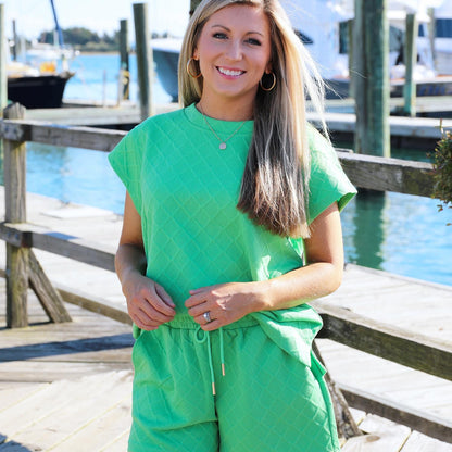 These textured sets come with a shirt as well as a bottom diamond pattern with a drawstring waist on the shorts they are light green and pink set colored Claire set, top and bottoms. 