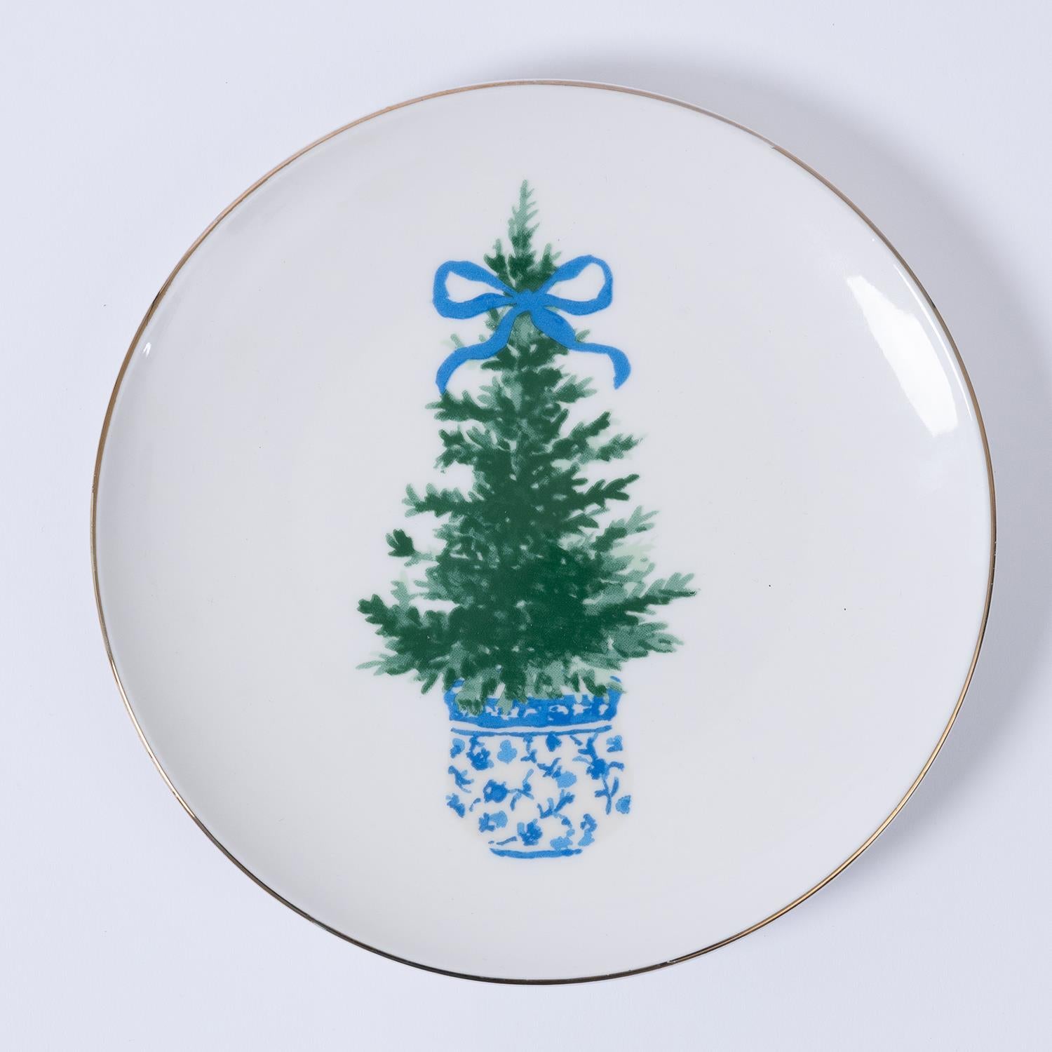 Fancy & Festive Appetizer Plate: White Christmas plate with a green tree in a blue pot, topped with a blue bow and gold rim. Sizes available: 7 inches.