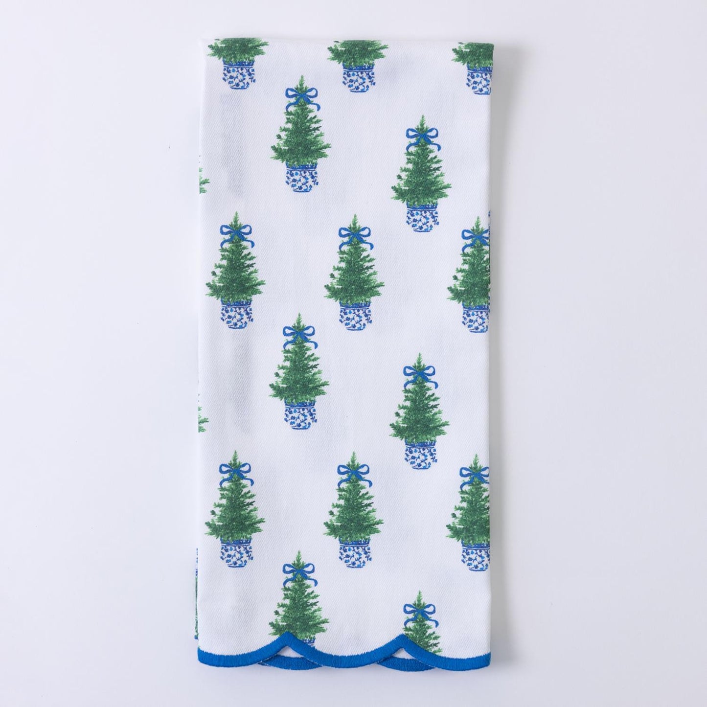 Festive Christmas Tea Towels feature green Christmas trees with blue bows in blue and white planters, accented by a scalloped blue edge. Available sizes: 16" x 28".