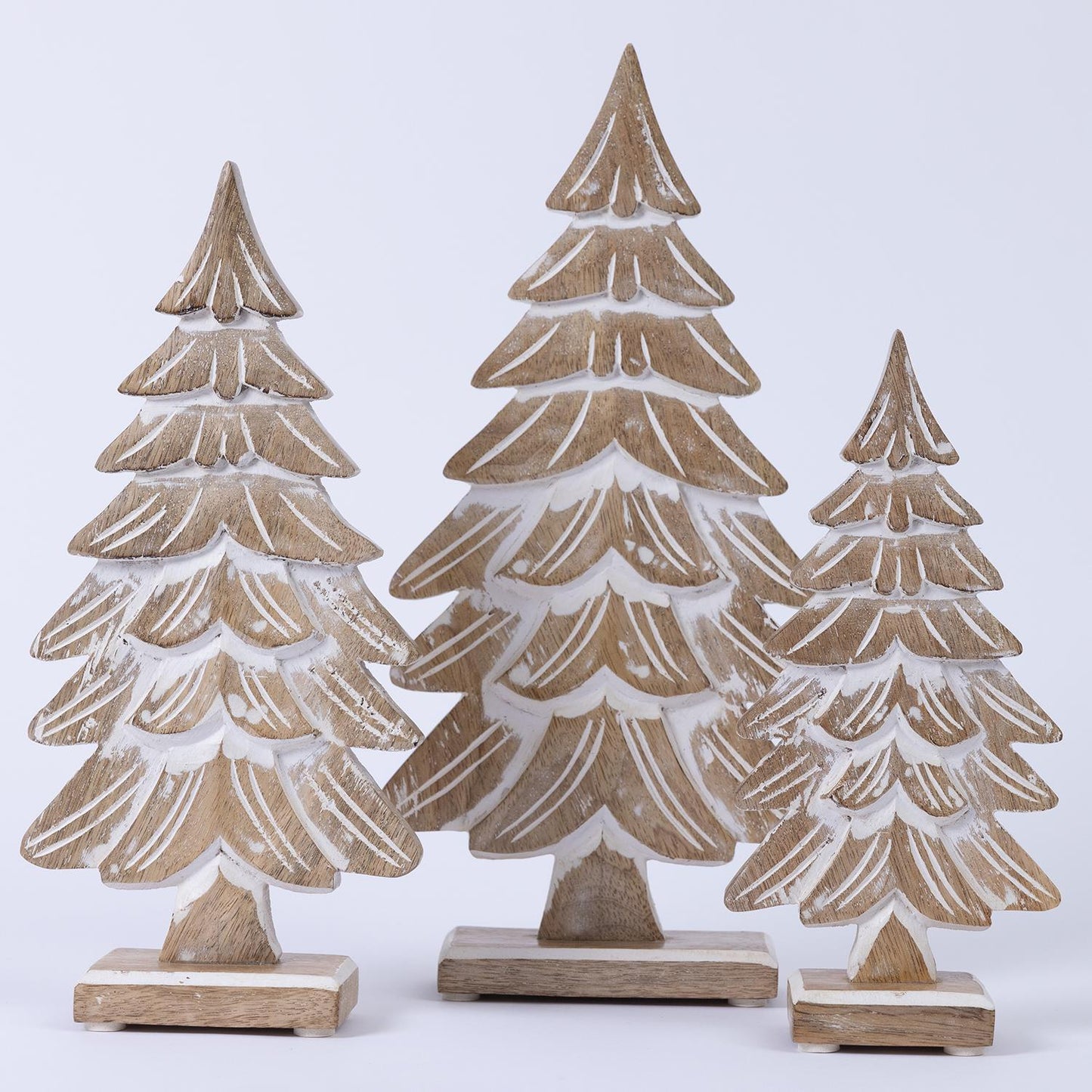 Wood Carved Pine Trees: Set of three on wooden bases with white accents. Sizes: Small, Medium, Large. Perfect for Christmas decor.