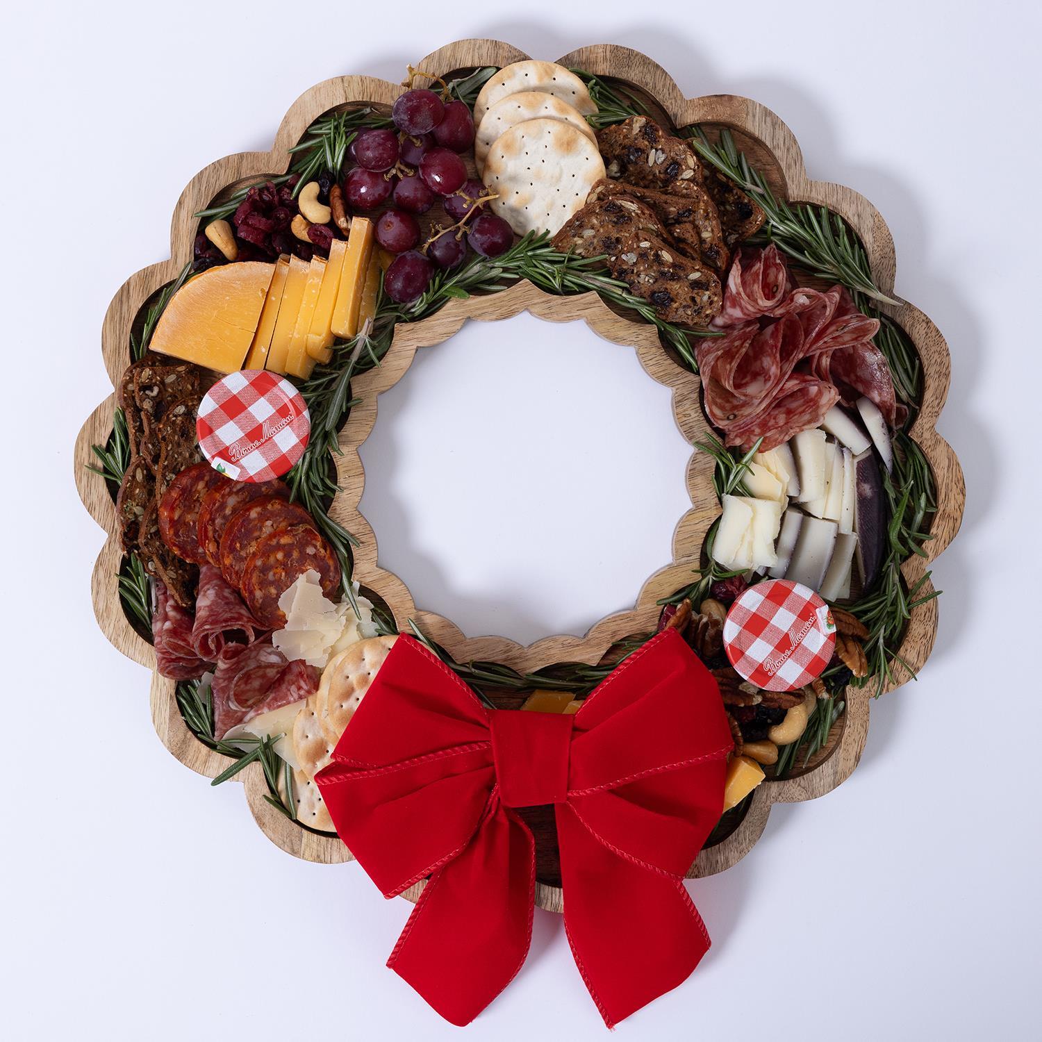 Wood Wreath Board with Bow: Features arranged cheese, meats, crackers, grapes, and rosemary. Includes festive red bow. Sizes: 12", 16", 20".