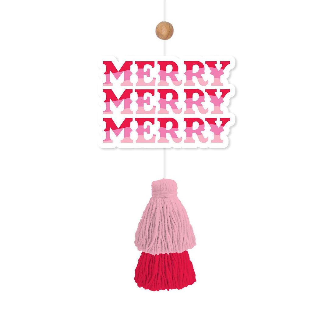 Rectangular cinnamon pine Holiday Car Air Freshener with “MERRY MERRY MERRY” in pink and red, featuring a two-tone pink and red yarn tassel.