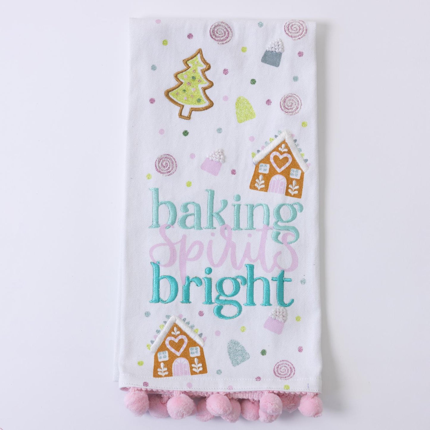 Festive Christmas Tea Towels feature pastel colors, embroidery of gingerbread houses, a Christmas tree, and candy. Include the phrase "baking spirits bright" and pink pom-poms. Available sizes: 18" x 28".