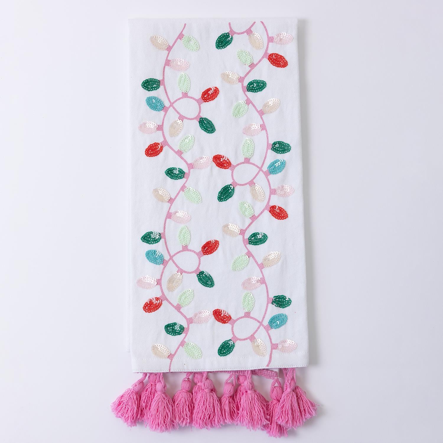 Festive Christmas Tea Towels: White fabric with embroidered colorful leaves in a swirling vine design. Accented with pink tassels on one edge. Sizes available: Standard towel size.