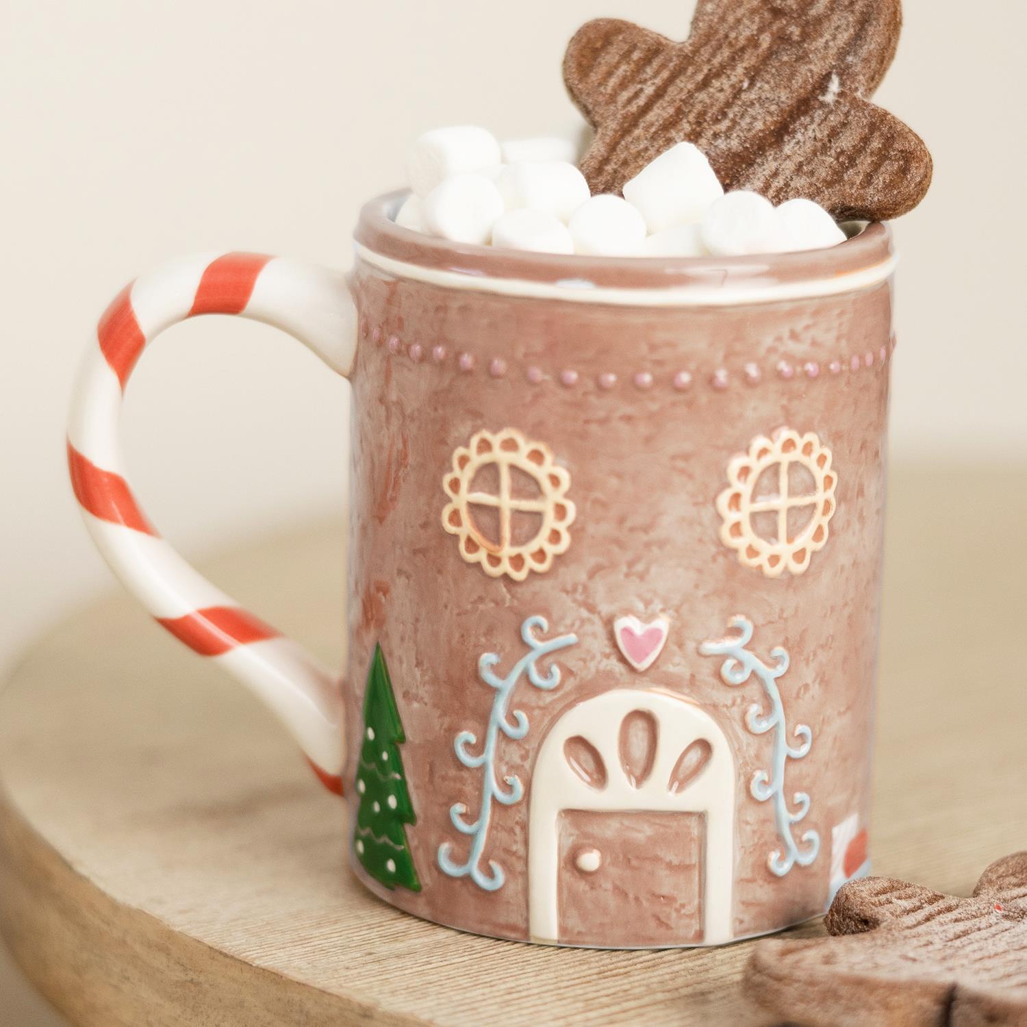 Christmas Themed Mug: Whimsical design with candy cane handle, marshmallows, gingerbread cookie topper. Available in standard size.