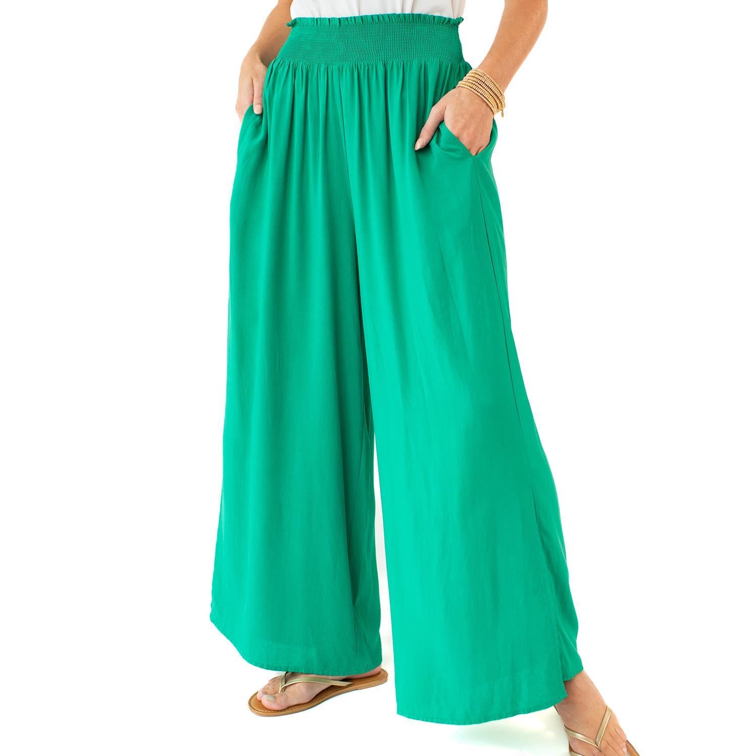 The Krista Pants in bright green feature a smocked waist and wide-leg design. Available sizes: XS, S, M, L.