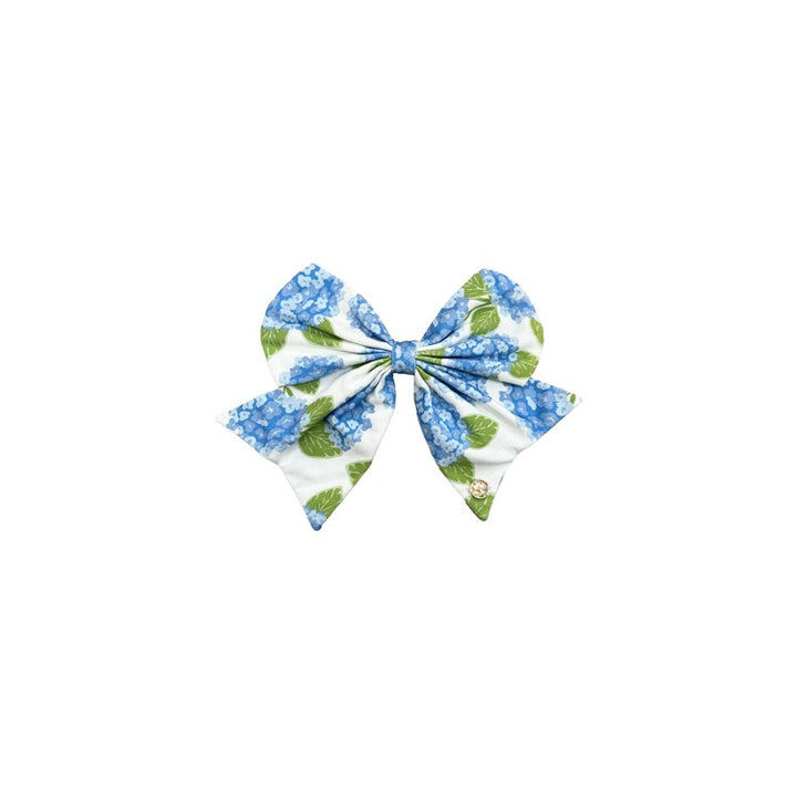 Fabric Magnetic Bows with blue hydrangea and green leaf print on white fabric. Available in small, medium, and large sizes.