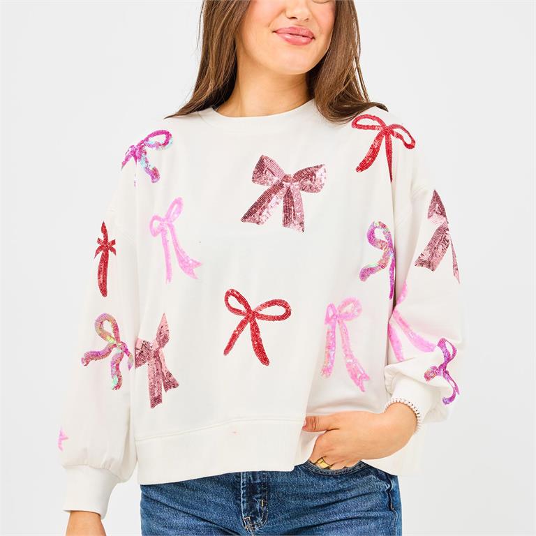 White long-sleeve Millie Bows Sweatshirt with scattered, multicolored sequined bows. Sizes available.