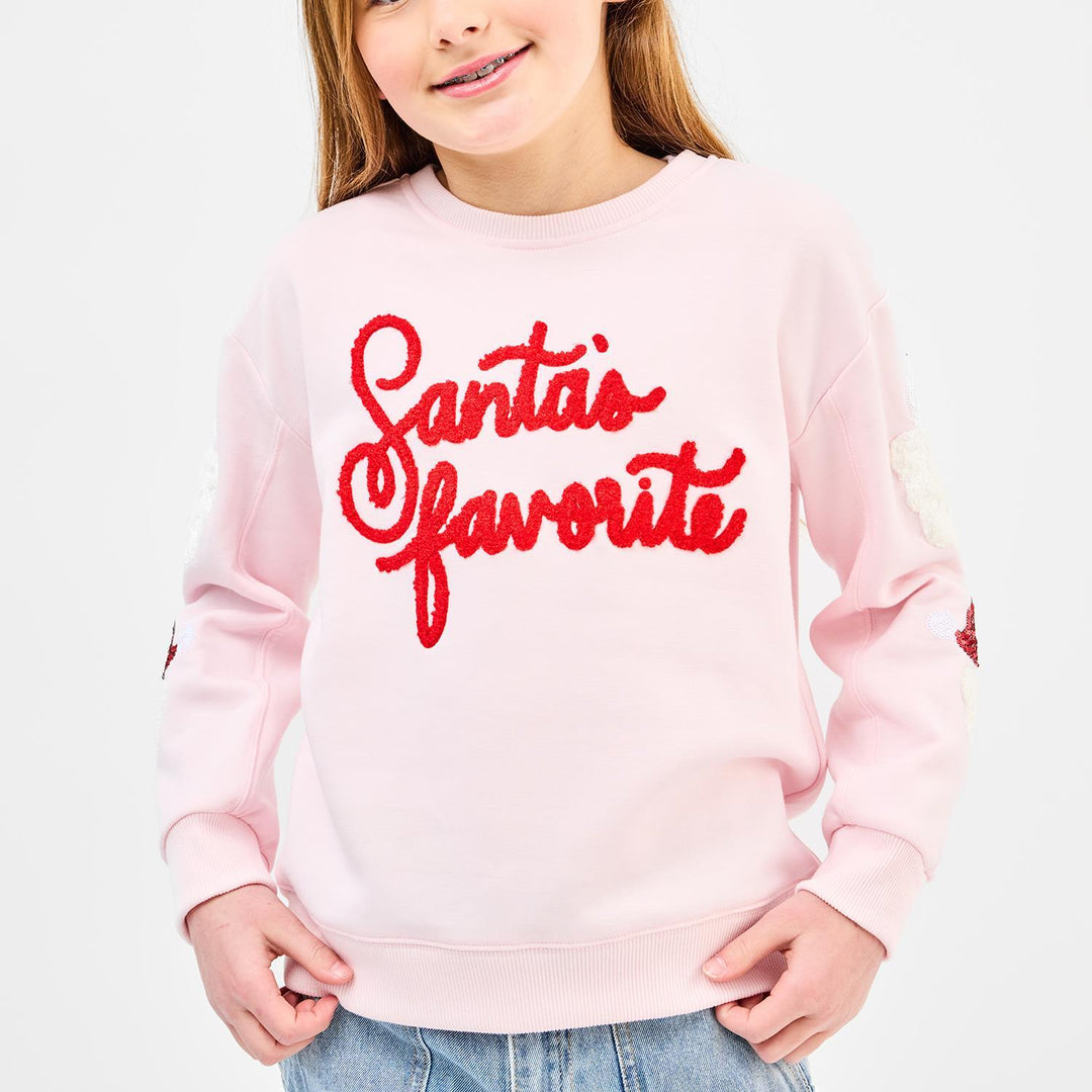 Light pink Sarah Santa’s Favorite Youth Sweatshirt with red script lettering and sequined sleeve accents.
