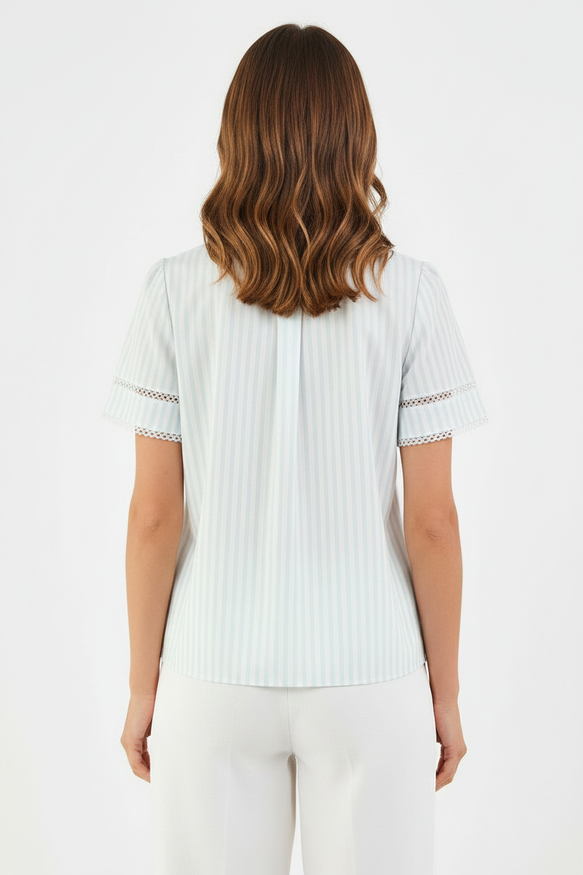 Tabby Pin Stripe Blue Top: light-colored, short-sleeve blouse with decorative lace trim. Available in sizes XS–XL.