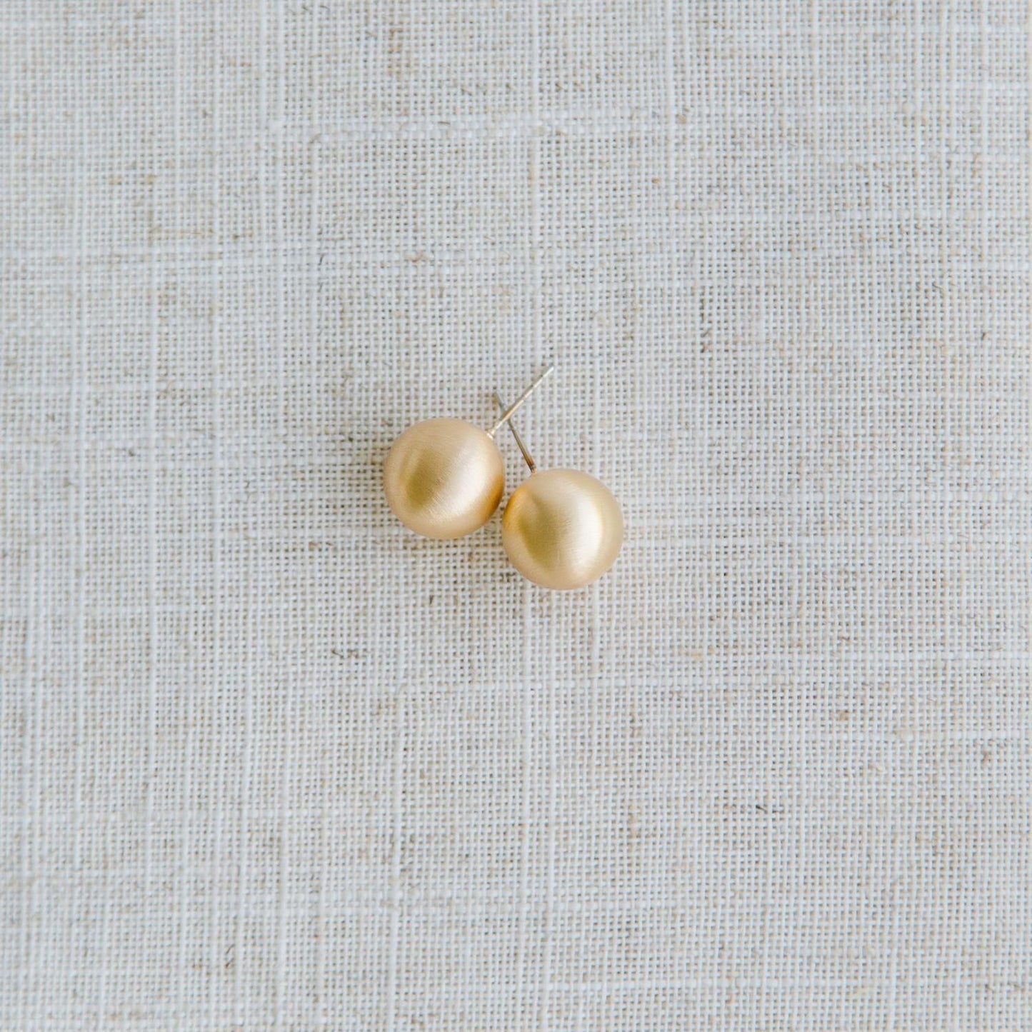 Round gold Grenada Earrings with hypoallergenic surgical steel posts. Available in small, medium, and large sizes.
