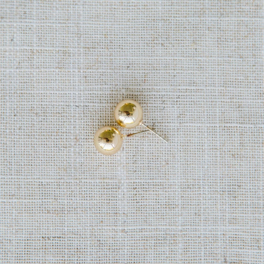 Grenada Earrings: Small, round gold stud earrings with hypoallergenic surgical steel posts. Available in one size.