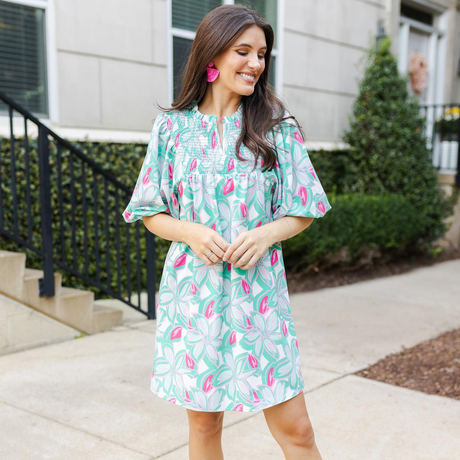 This LuLaRoe Amelia Paradise View Mint Dress features a vibrant teal and pink floral pattern. Sizes available range from XS to XL. Matching pink earrings are not included.