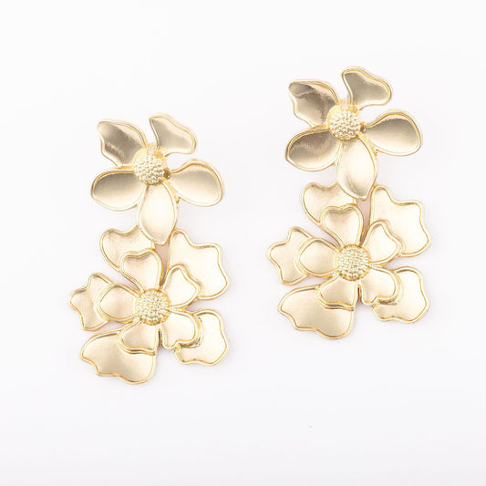 Scarlet Earrings: Gold-colored, flower-shaped with intricate petal details and textured centers. Each lightweight earring features three connected flowers stacked vertically. Elegant and stylish, suitable for formal or semi-formal wear. Sizes available: One size fits all.