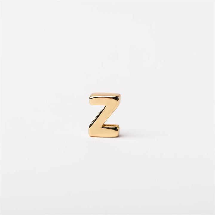 Small gold-colored metallic letter "Z" charm, available in multiple sizes.