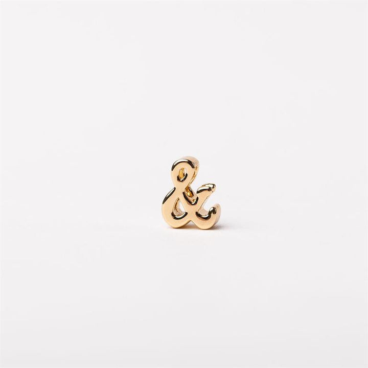 Small gold-colored ampersand pin; available in multiple sizes.