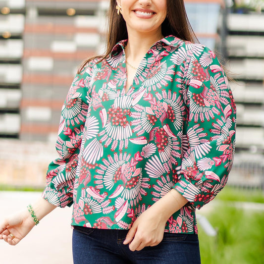 Charlee Toucan Tango Pink Top features a vibrant floral pattern in shades of green, pink, and white. Available sizes: S, M, L.