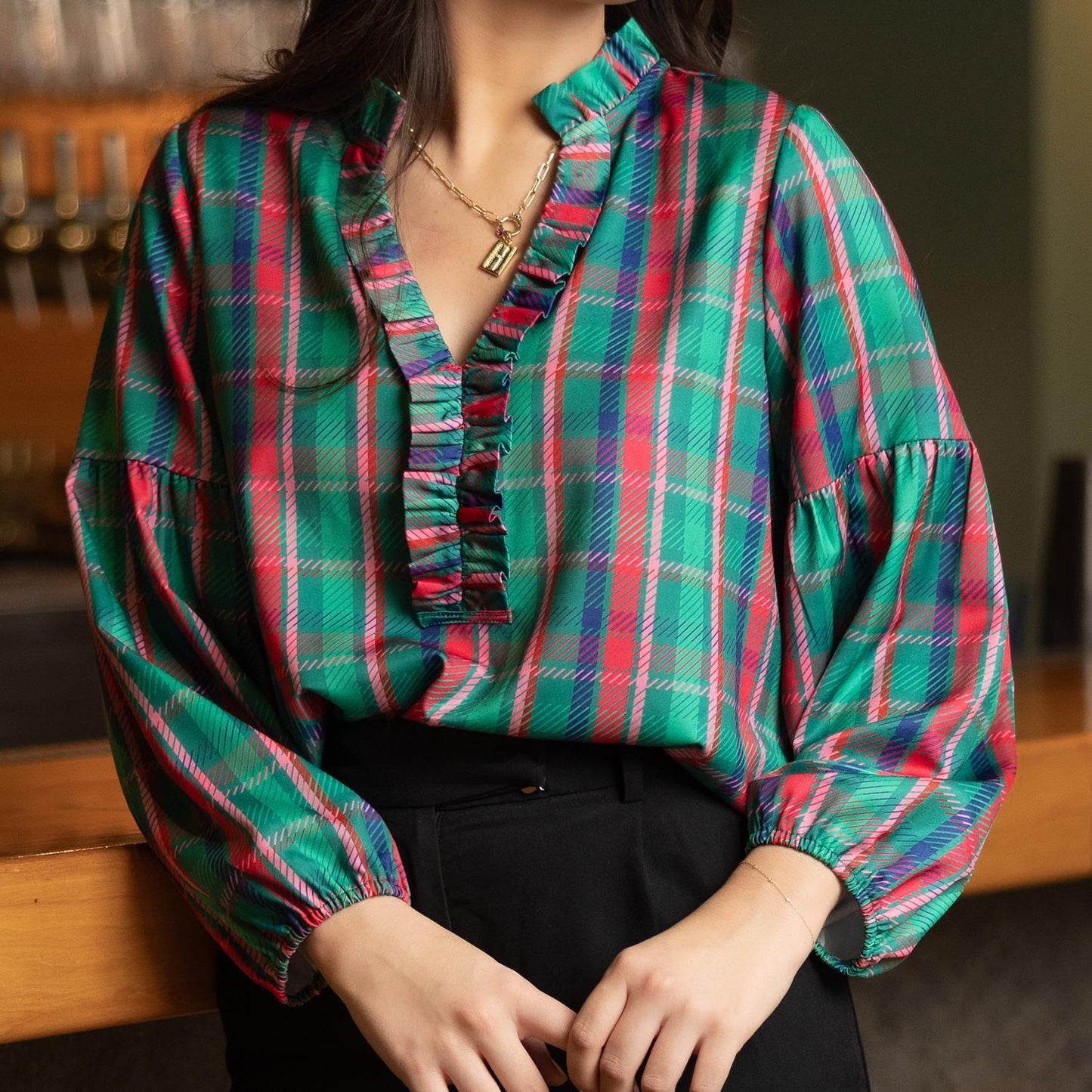 Lexi Plaid About You Green Top with frill V-neck details in shades of green, red, and blue. Sizes available: XS, S, M, L, XL.