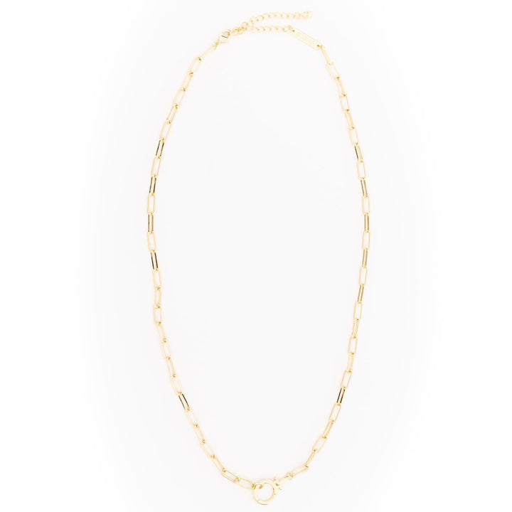 Thea Charm Bar is an 18k gold-plated, hypoallergenic necklace with elongated rectangular links and an adjustable clasp, designed for customizable charms. Available in multiple lengths.