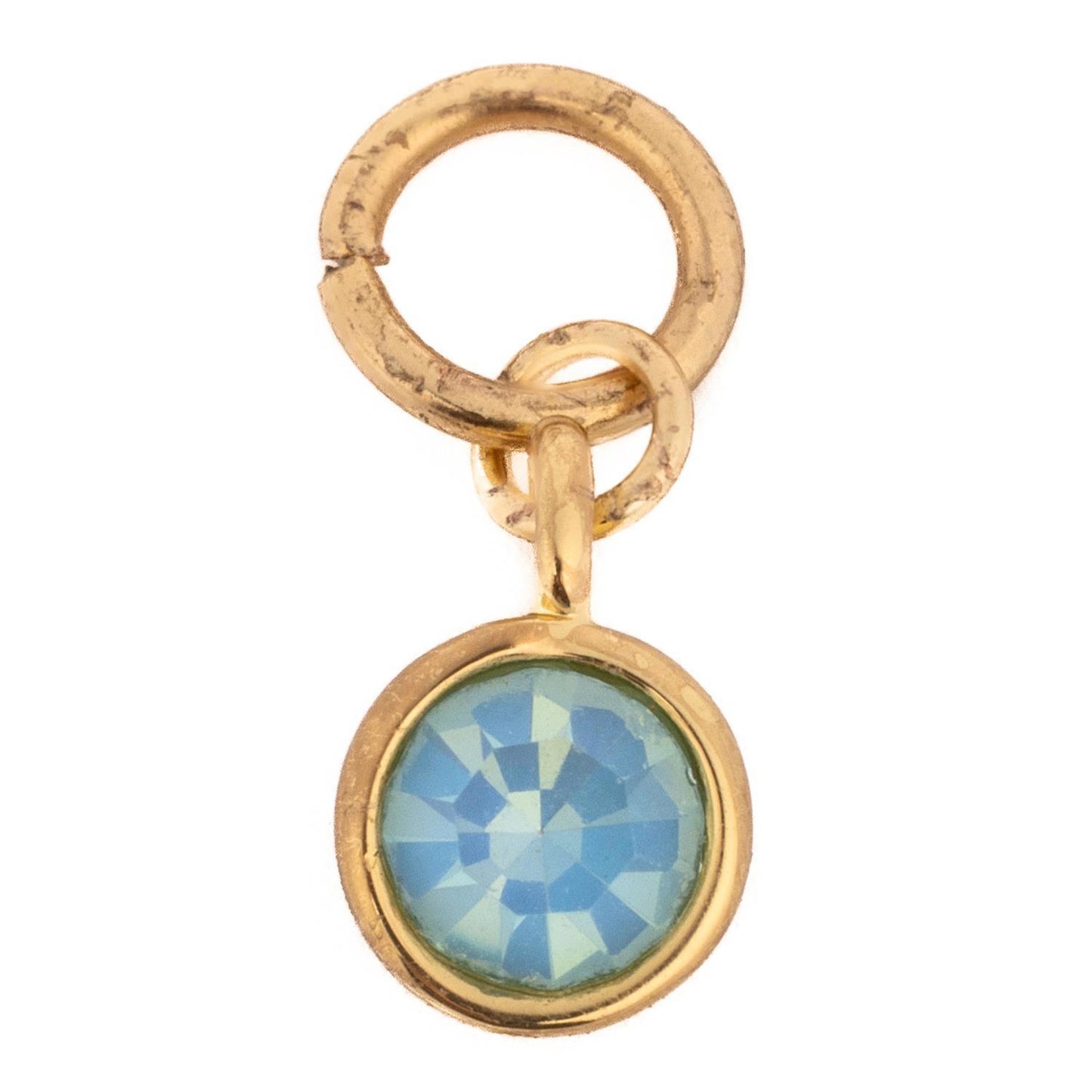 Thea Charm Bar: Petite gold pendant with a round faceted blue gemstone in a bezel setting and two gold loops; available in one size.