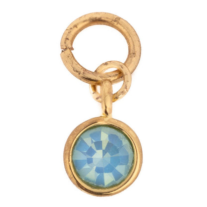 Thea Charm Bar: Petite gold pendant with a round faceted blue gemstone in a bezel setting and two gold loops; available in one size.